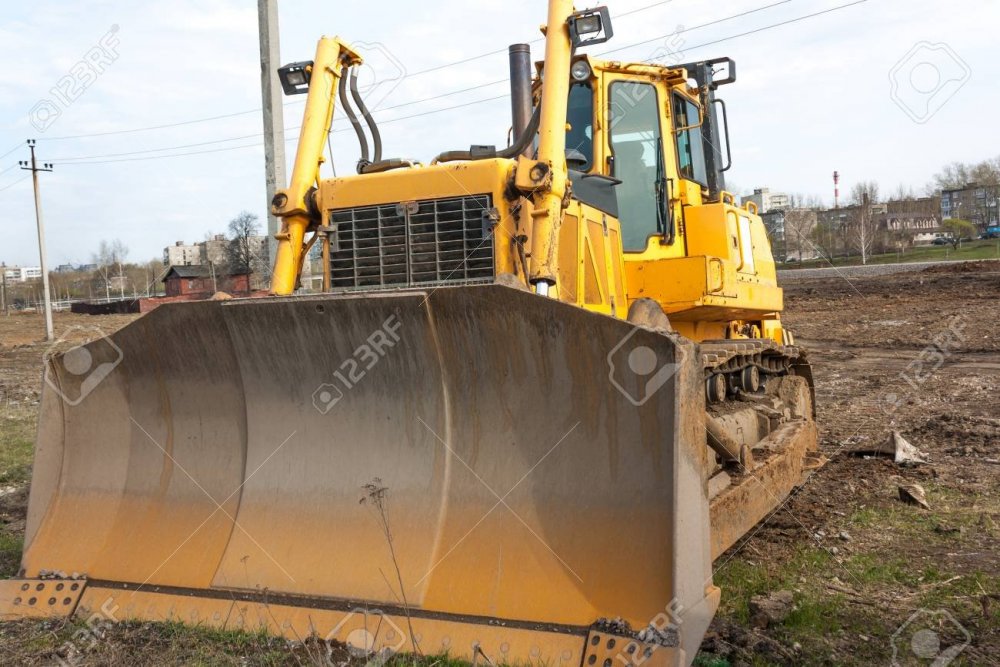 80013270-bulldozer-huge-orange-powerful-construction-machine-with-hydraulic-piston-of-scoop-and-black-wheels-.jpg